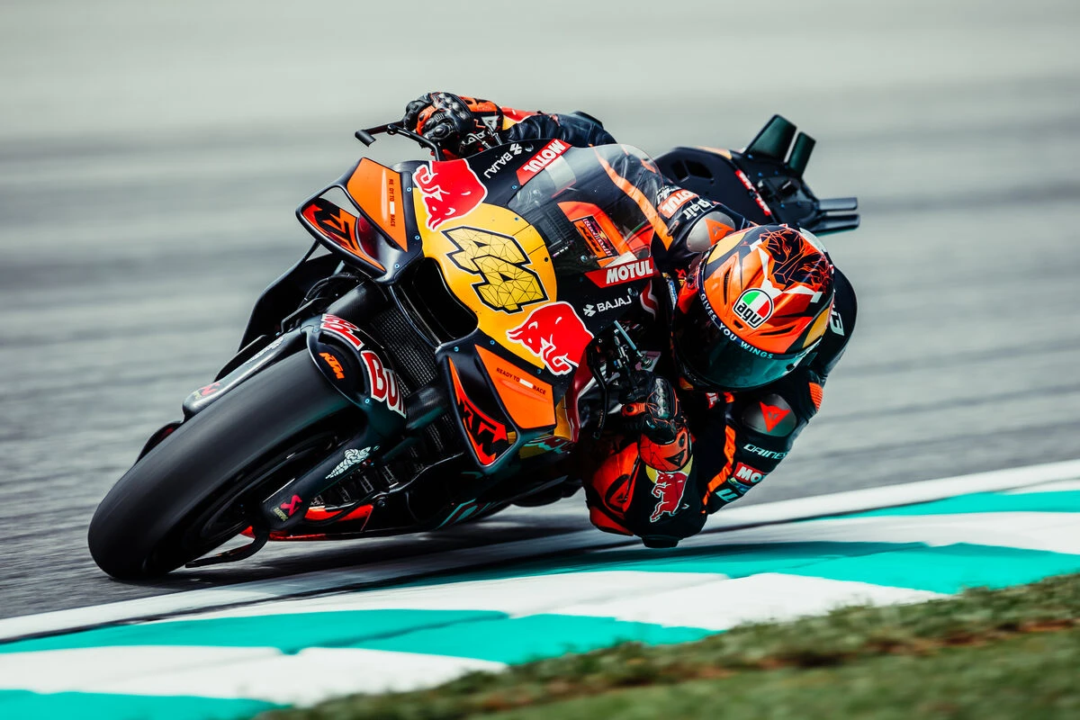 Pol Espargaró a Red Bull KTM csapat színeiben szemből fotózva ahogy kanyarodik balra és mélyen dönti a MotoGP motort.